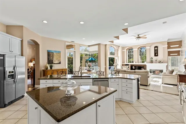a living room with furniture kitchen view and a table