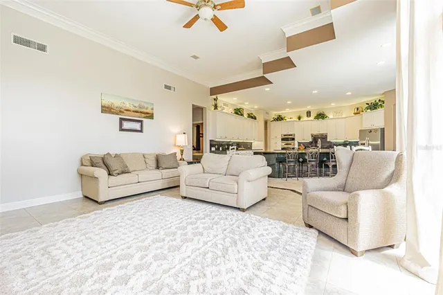 a bedroom with furniture and a large window