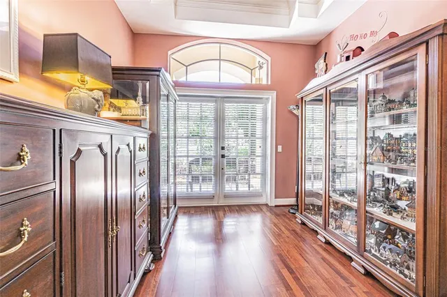 a bedroom with a bed and a flat tv screen on dresser