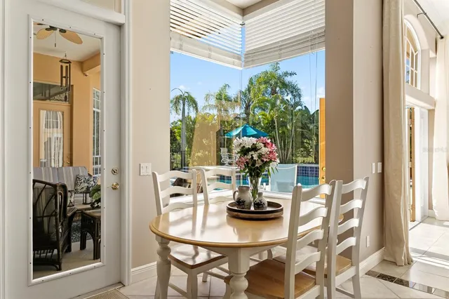 a bedroom with a bed and large windows