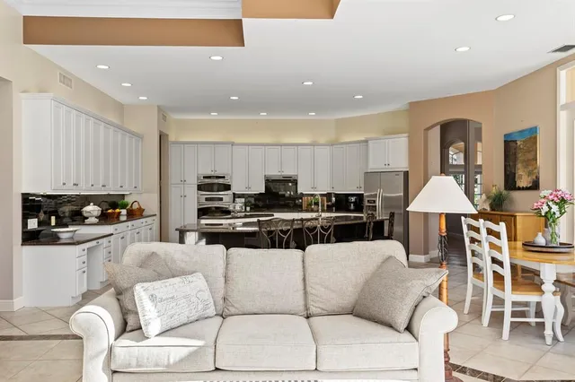 a bedroom with a bed and large windows