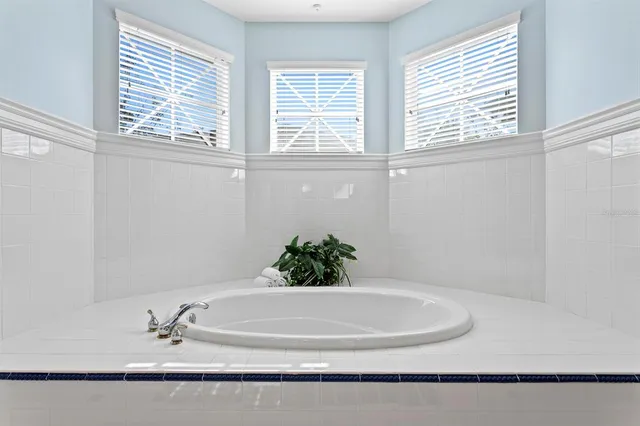 a view of a patio with couches table and chairs with potted plants
