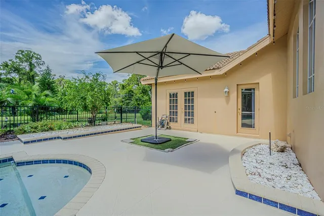 a aerial view of a house with table and chairs and potted plants