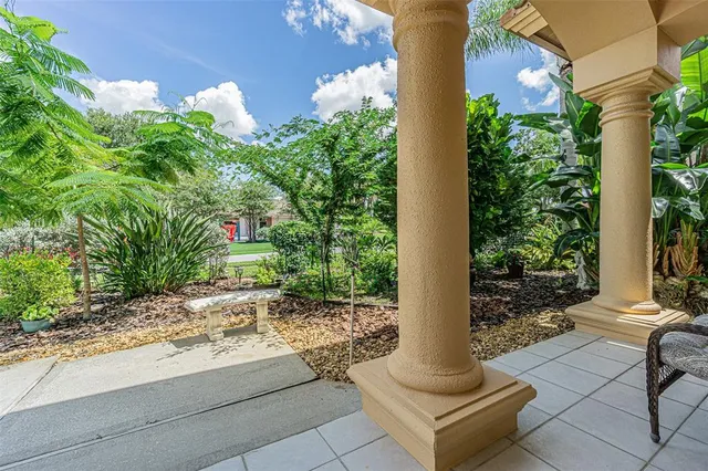 a balcony with outdoor seating and green space