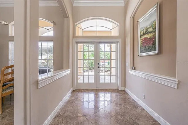 a living room with furniture a glass table and a large window
