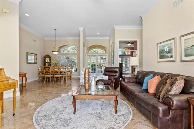 a dining room with furniture and chandelier