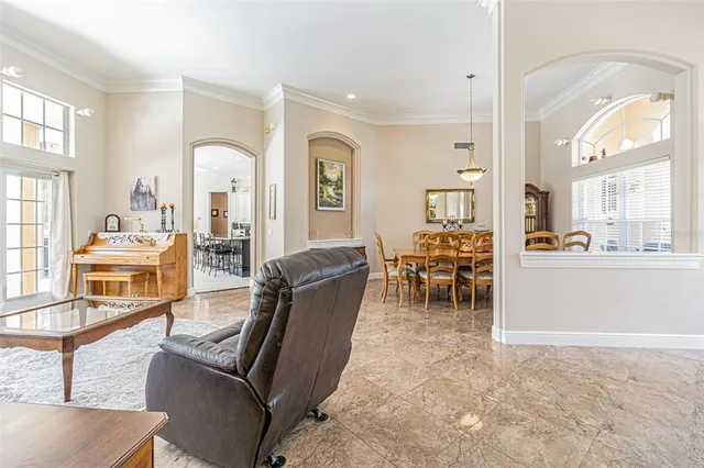 a dining room with furniture a chandelier and a rug