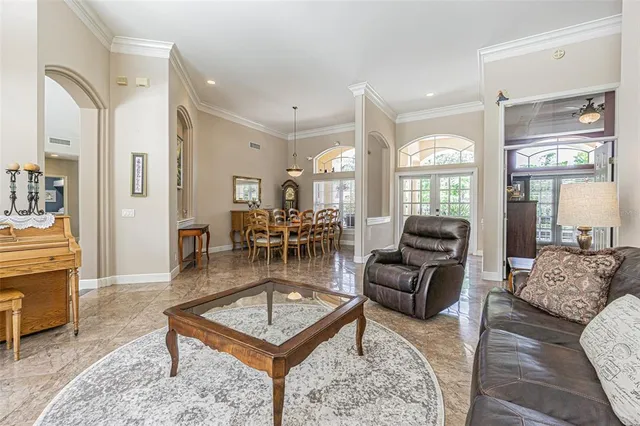 a kitchen with stainless steel appliances kitchen island granite countertop a stove a refrigerator and white cabinets