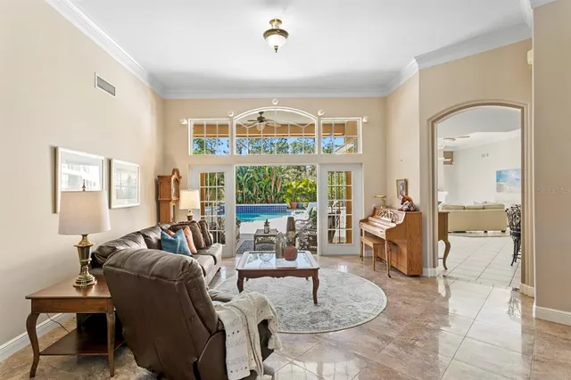 a kitchen with stainless steel appliances kitchen island granite countertop a table chairs sink and cabinets