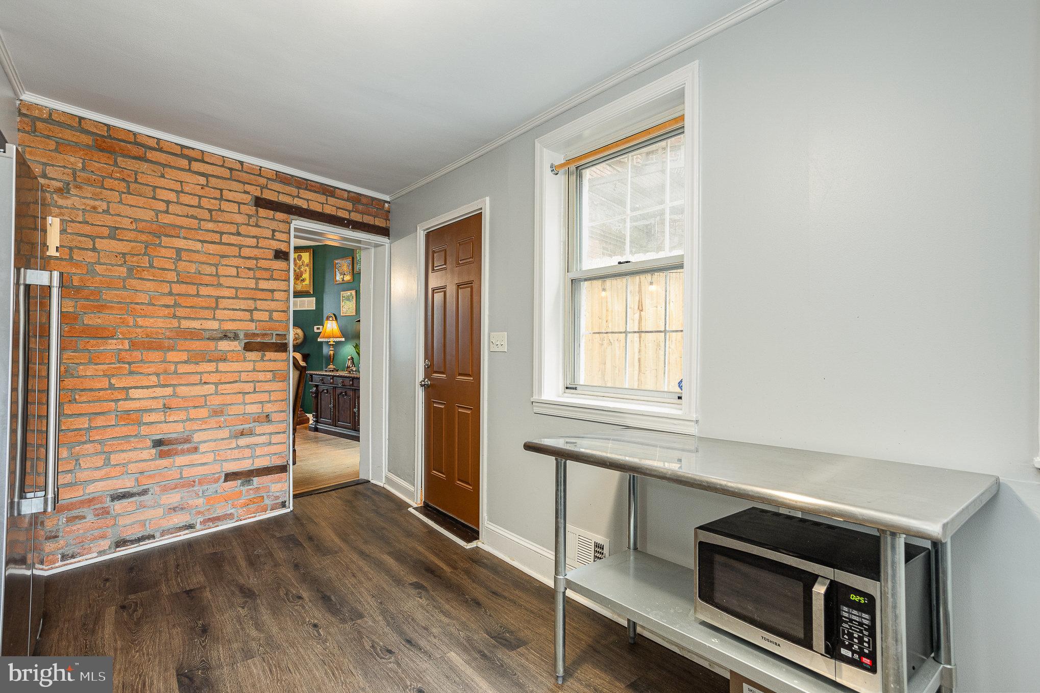 604 Washington Boulevard Baltimore, MD 21230 - Photo 13 of 30 a kitchen with granite countertop cabinets stainless steel appliances and wooden floor