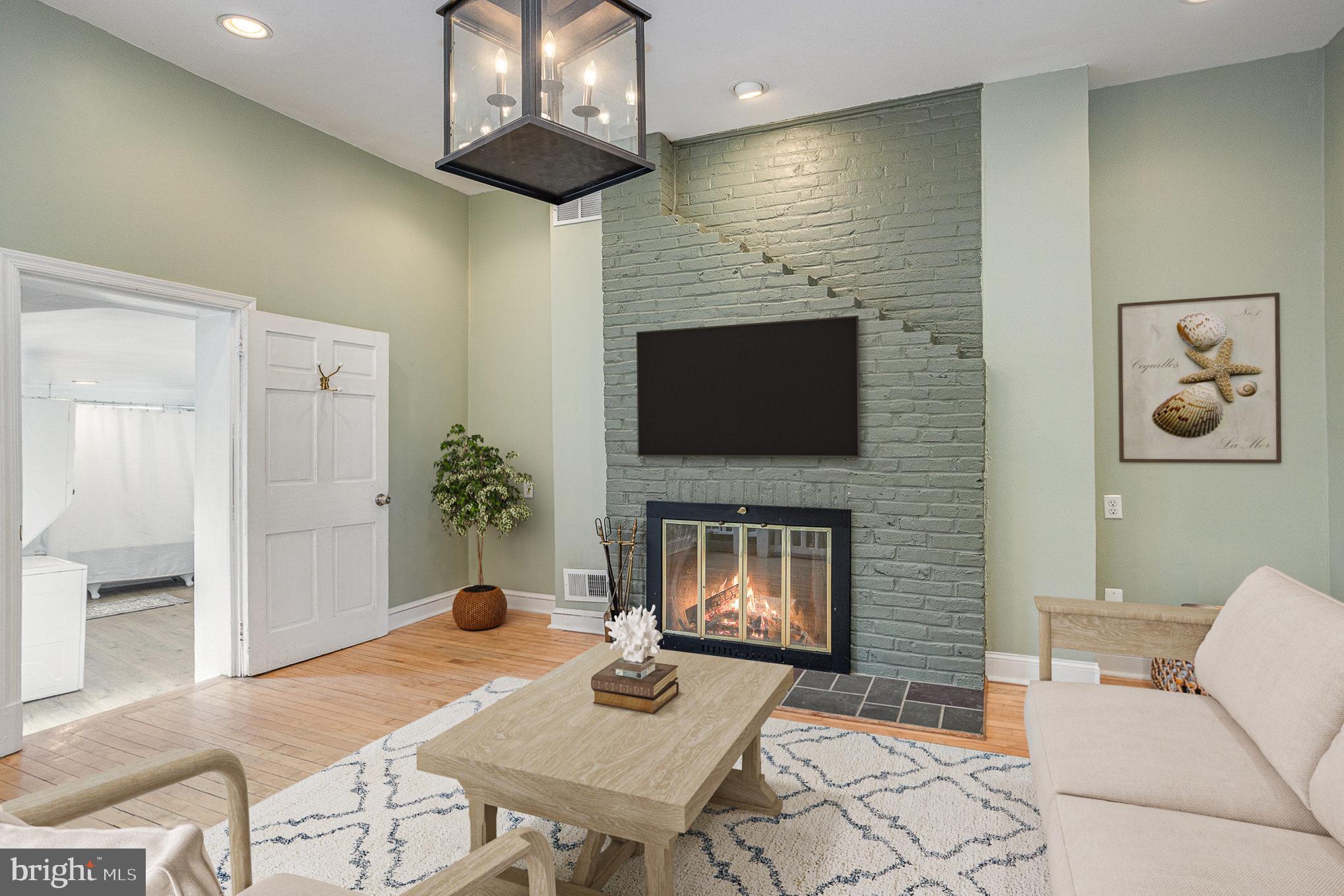 604 Washington Boulevard Baltimore, MD 21230 - Photo 14 of 30 a living room with furniture a fireplace and a flat screen tv