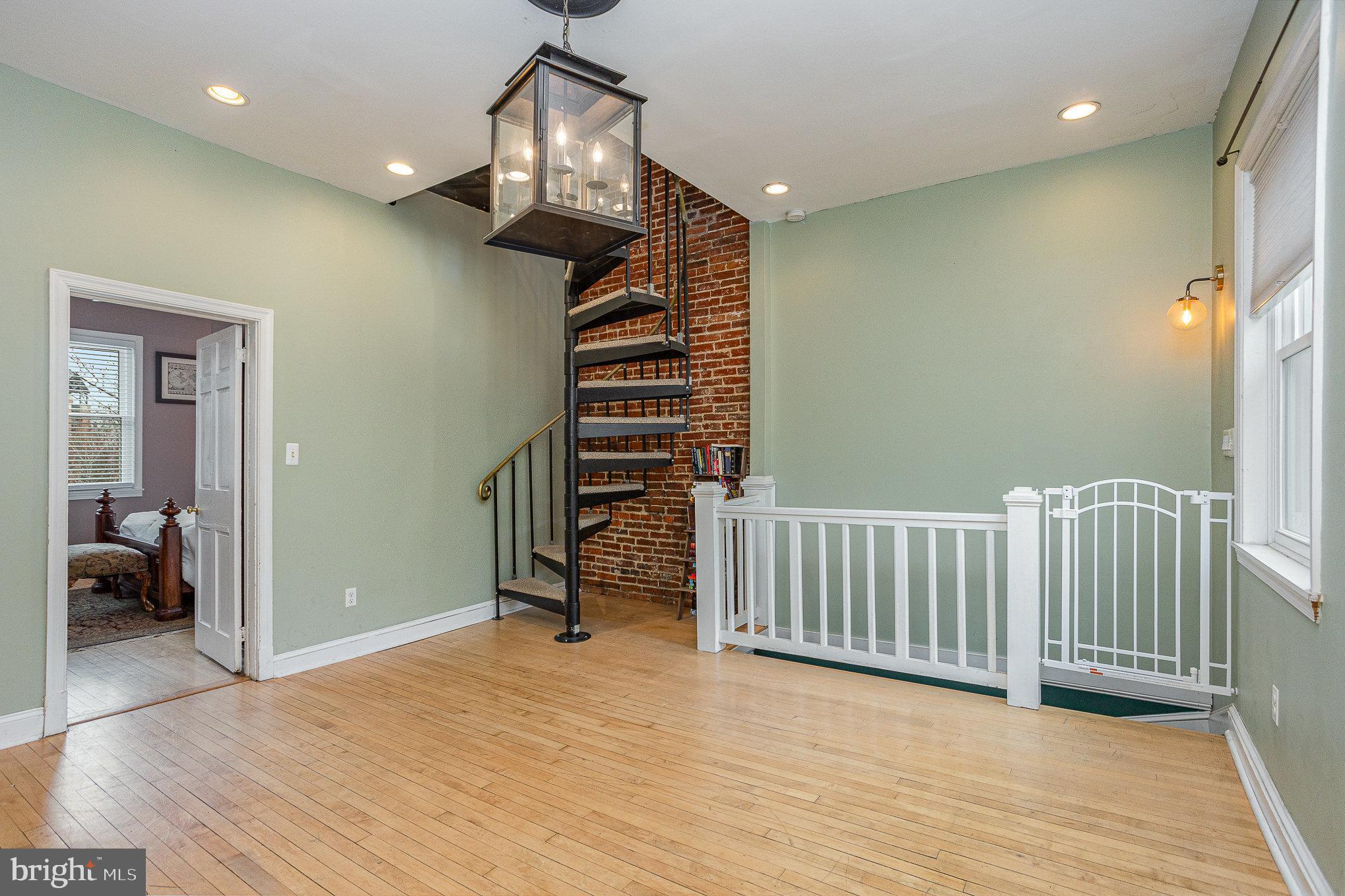 604 Washington Boulevard Baltimore, MD 21230 - Photo 16 of 30 a view of a livingroom with wooden floor and stairs