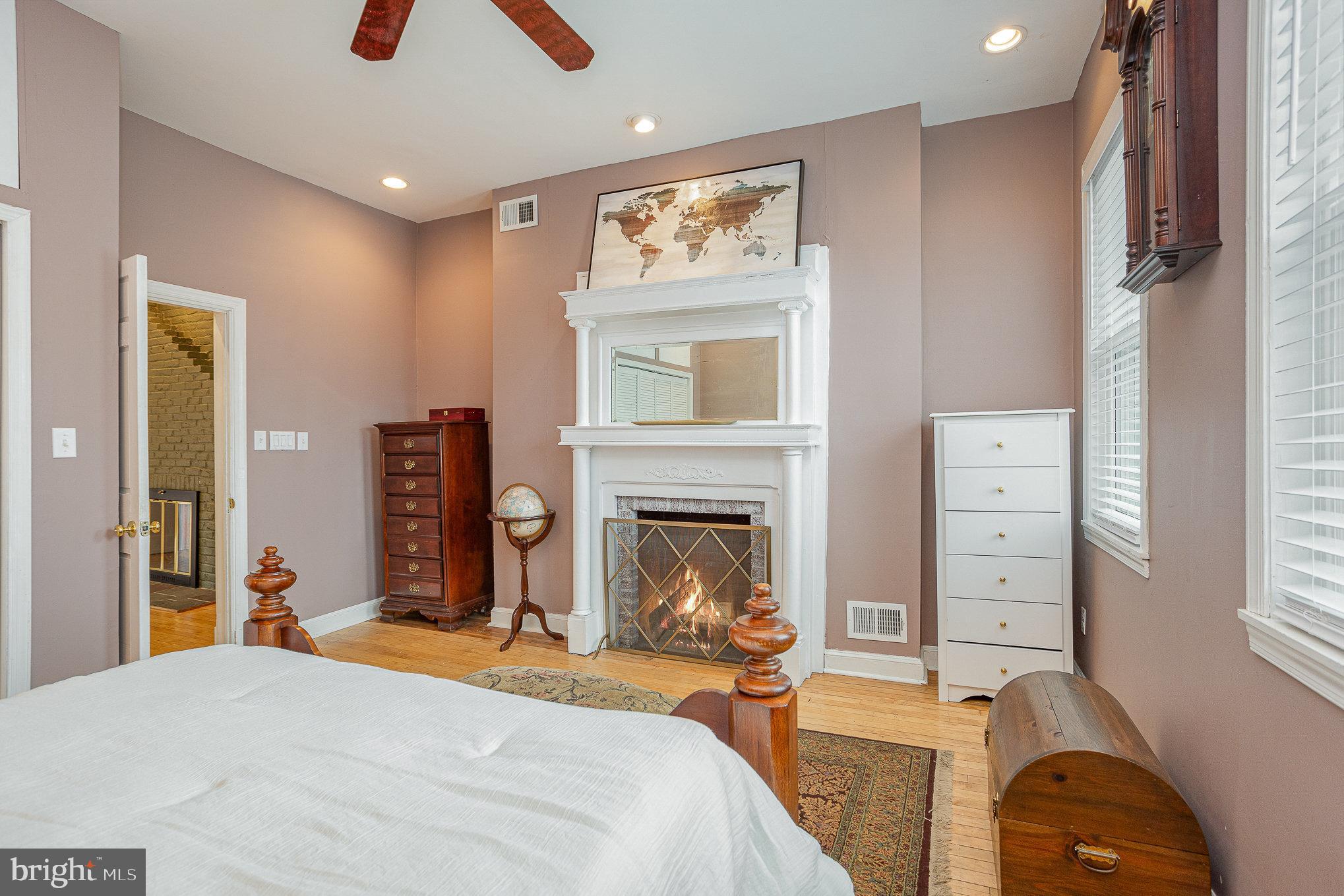 604 Washington Boulevard Baltimore, MD 21230 - Photo 18 of 30 a bedroom with furniture and a fireplace