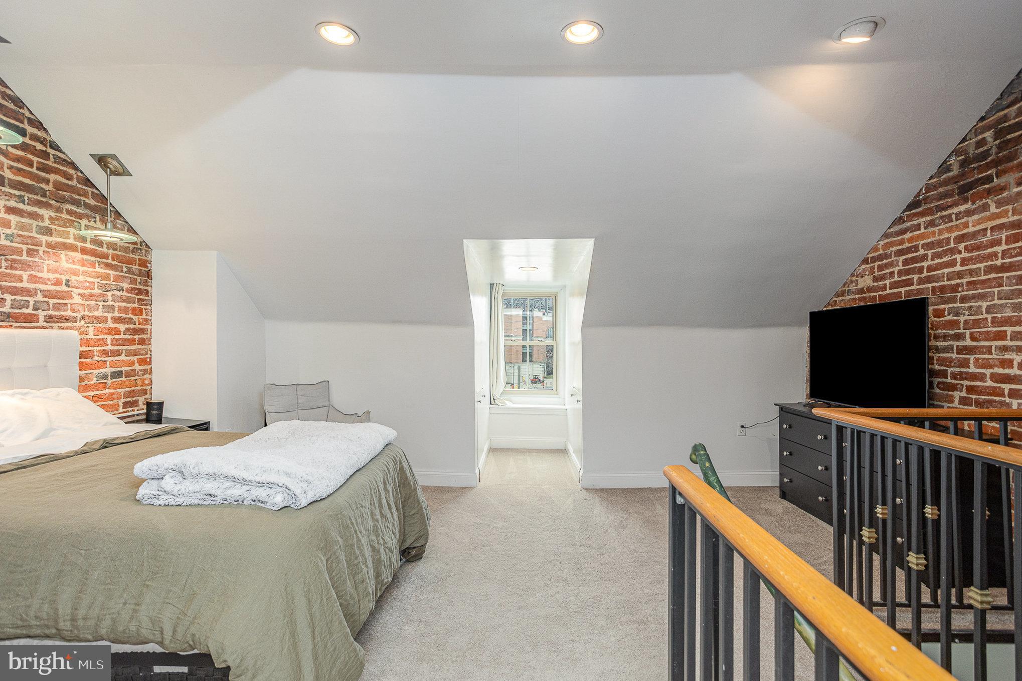 604 Washington Boulevard Baltimore, MD 21230 - Photo 22 of 30 a bedroom with a bed and a flat screen tv