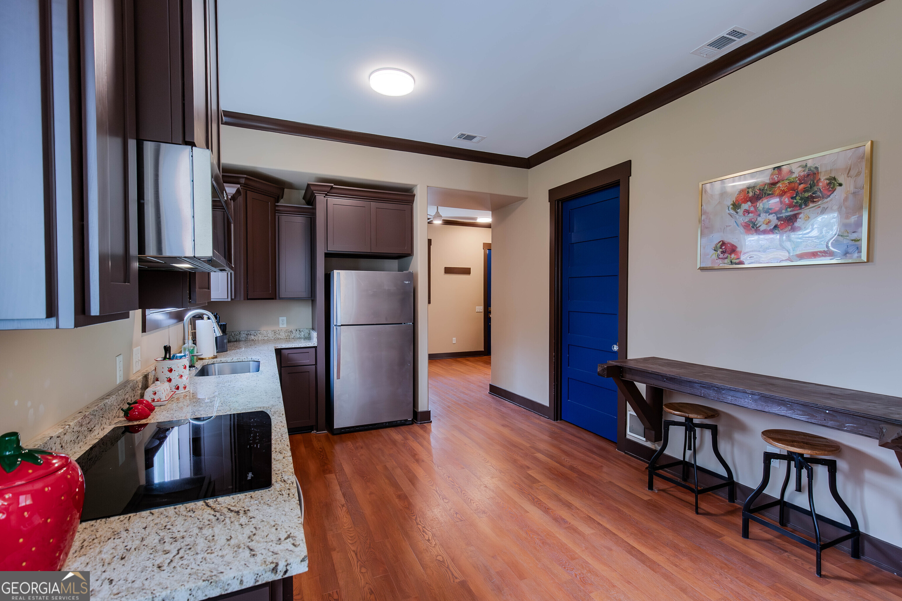 180 South Main Street Ludowici, GA 31316 - Photo 2 of 43 a kitchen with stainless steel appliances wooden floor and a refrigerator