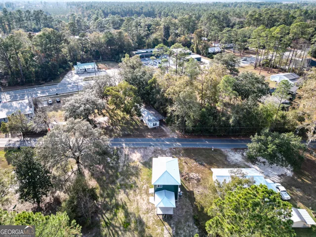 an aerial view of a house with a yard
