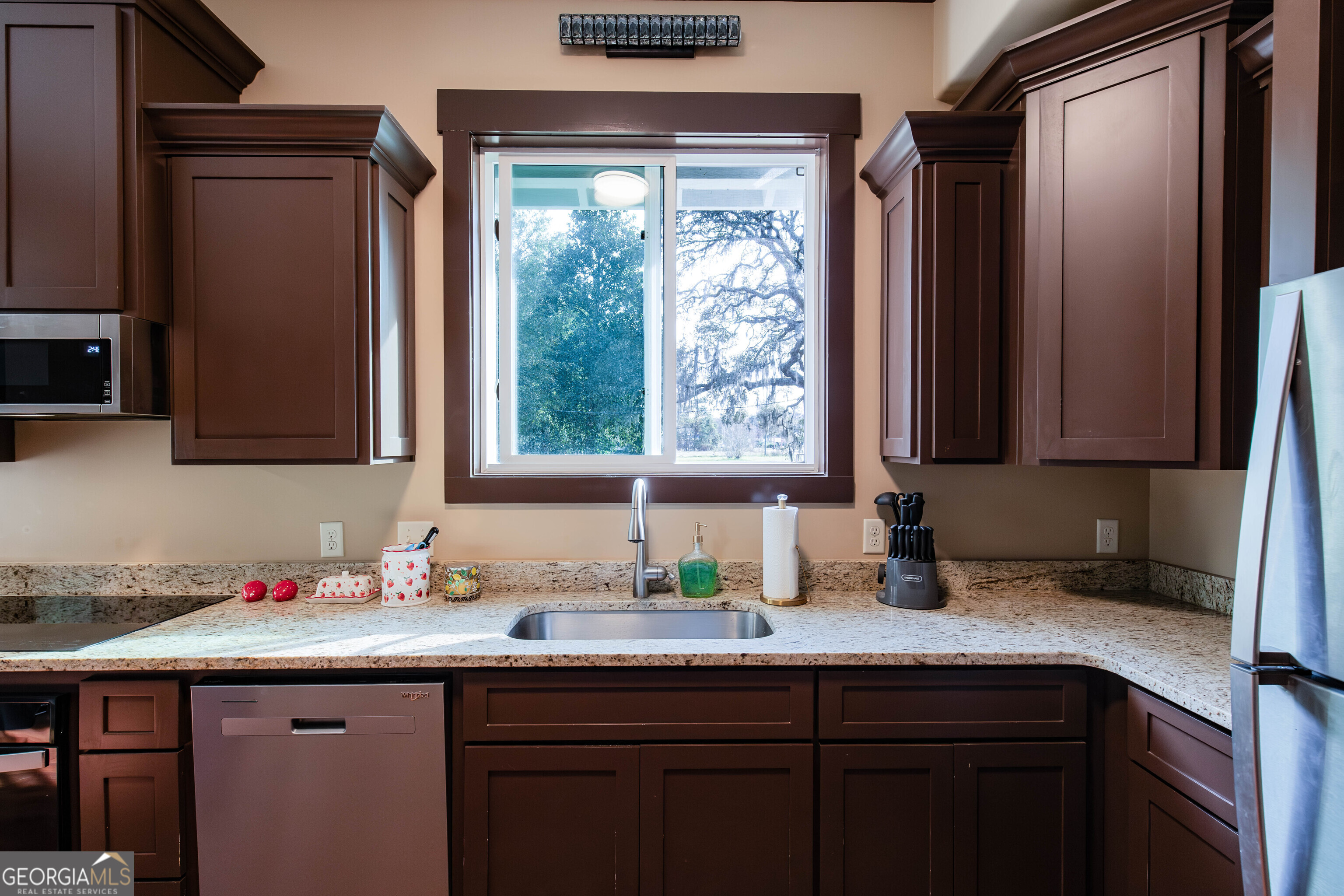 180 South Main Street Ludowici, GA 31316 - Photo 3 of 43 a kitchen with granite countertop a sink and a window