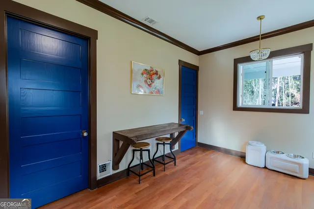 a view of a workspace with furniture and wooden floor