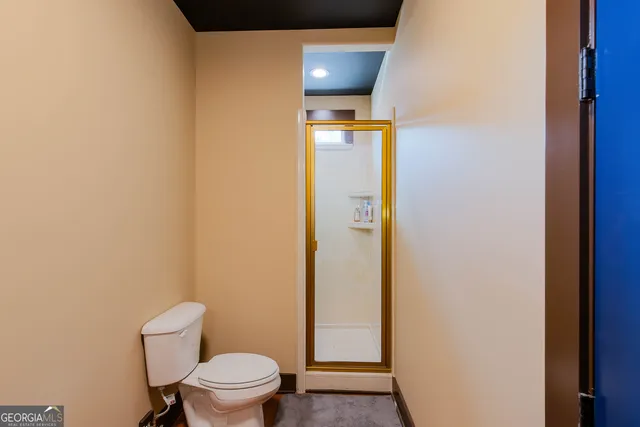 a bathroom with a toilet and a shower