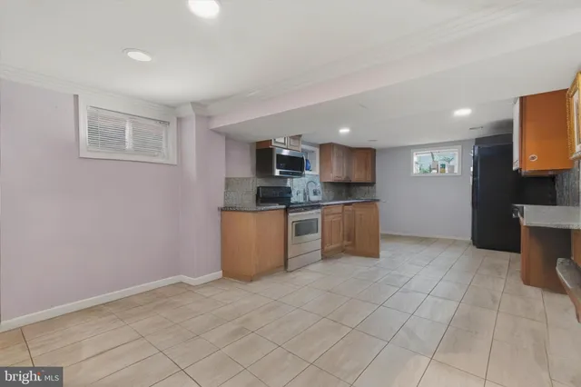 a kitchen with stainless steel appliances a refrigerator sink and microwave