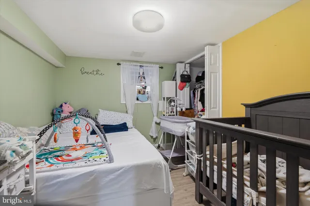 a bedroom with furniture and baby crib