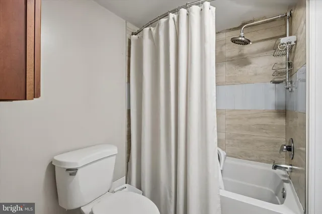 a bathroom with a toilet and shower