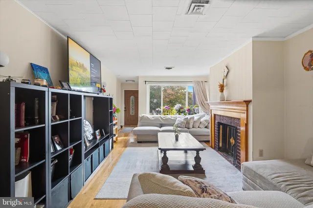 a living room with furniture fireplace and a window