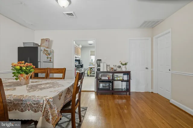 a dining room with furniture and wooden floor