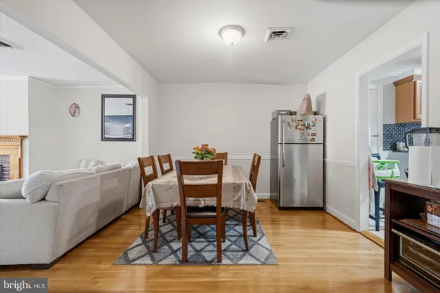 a dining room with furniture and wooden floor