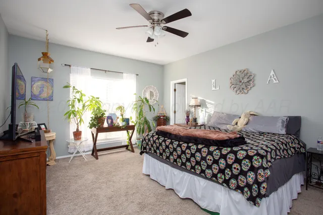 a bedroom with a bed window and a couch