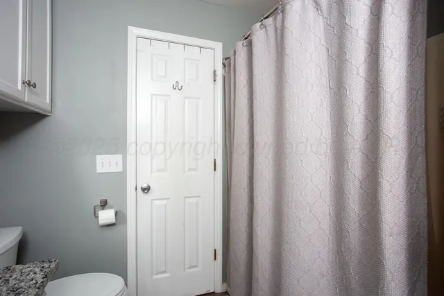 a bathroom with a shower curtain