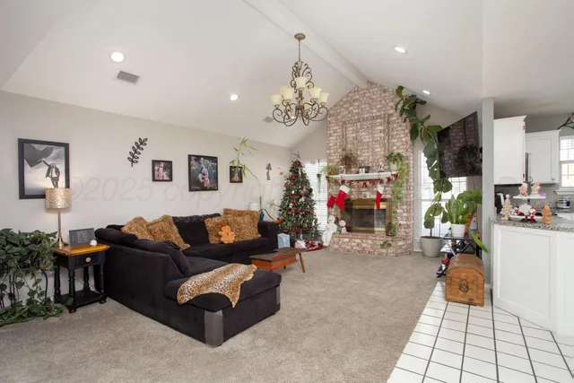 a living room with furniture and a chandelier