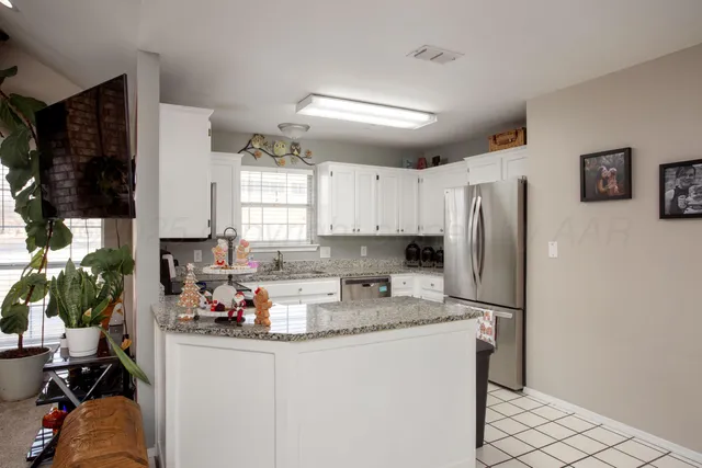 a kitchen with refrigerator and window