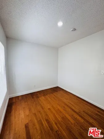 a view of an empty room and a window