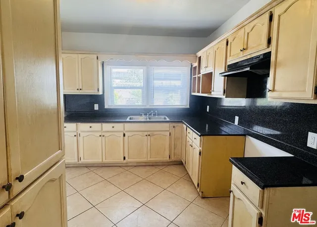 a kitchen with stainless steel appliances granite countertop a sink and a stove