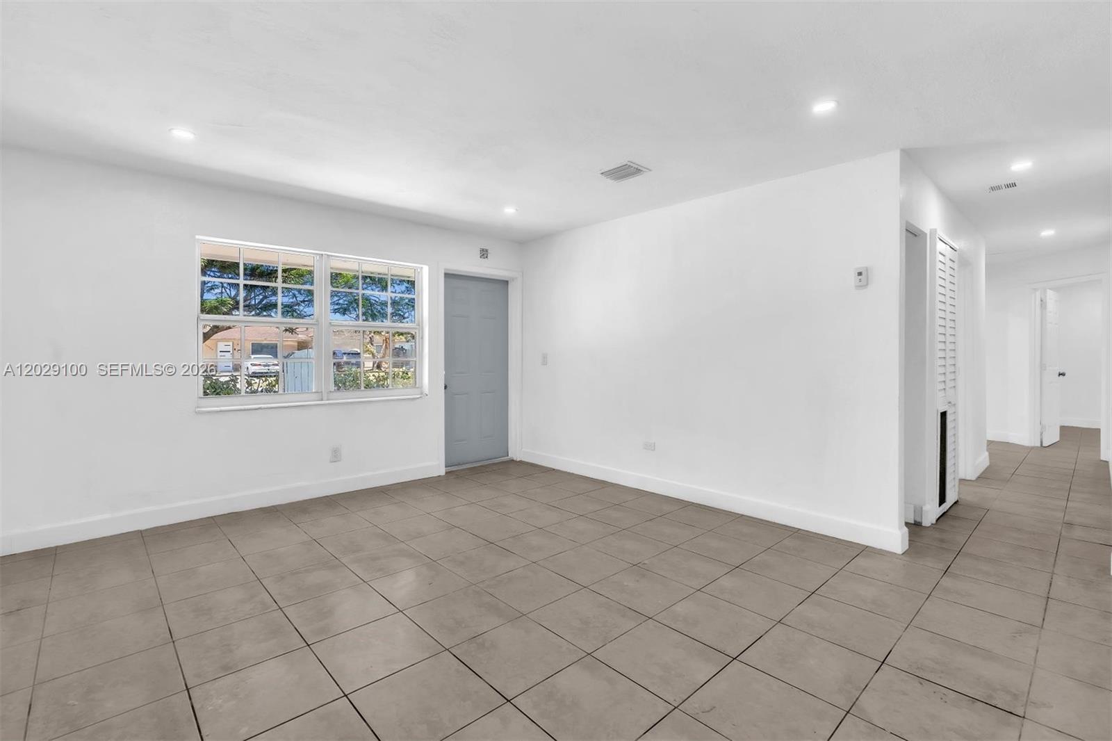 11790 Southwest 34th Street Miami, FL 33175 - Photo 4 of 56 an empty room with cabinet and mirrors