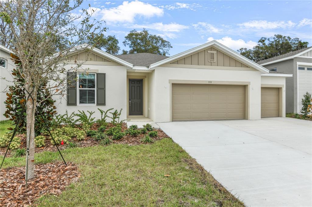 333 Alexandrite Street DeLand, FL 32720 - Photo 1 of 1 a front view of a house with a garden