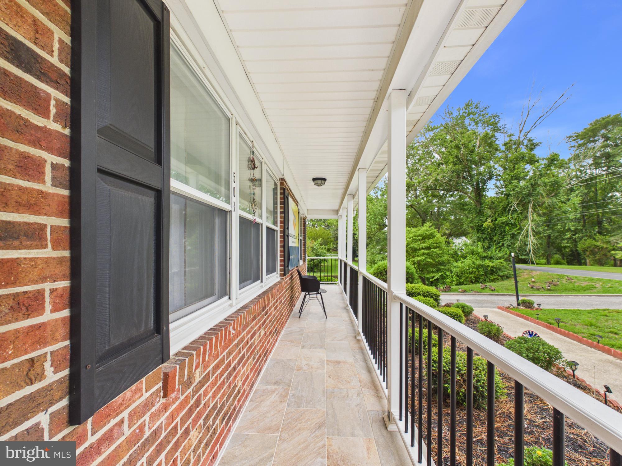 503 Gunby Road Salisbury, MD 21804 - Photo 26 of 36 Charming porch with lush greenery.