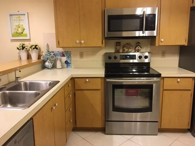 a kitchen with stainless steel appliances granite countertop a sink stove and microwave
