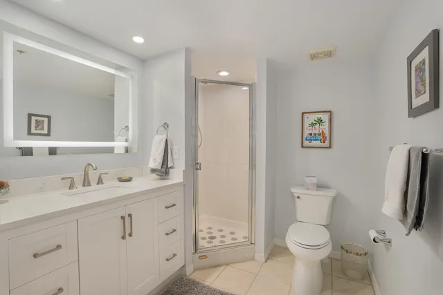 a bathroom with a toilet sink and a mirror