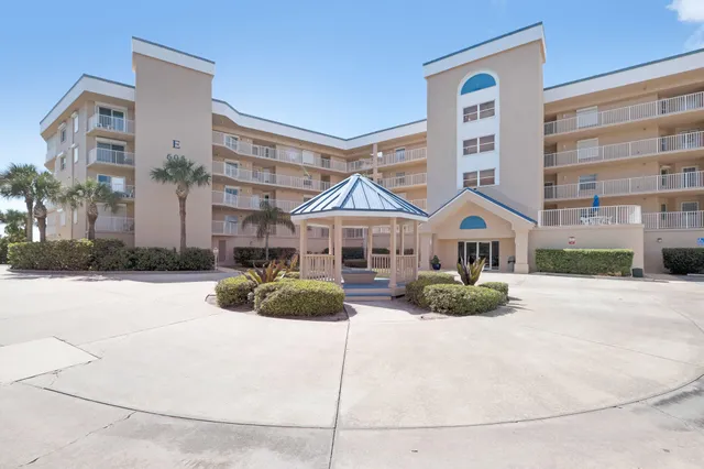 a dining room with furniture a chandelier and wooden floor