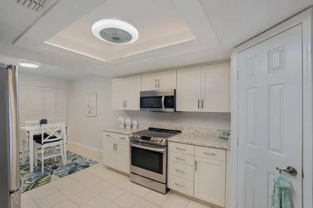 a kitchen with granite countertop a stove and a sink