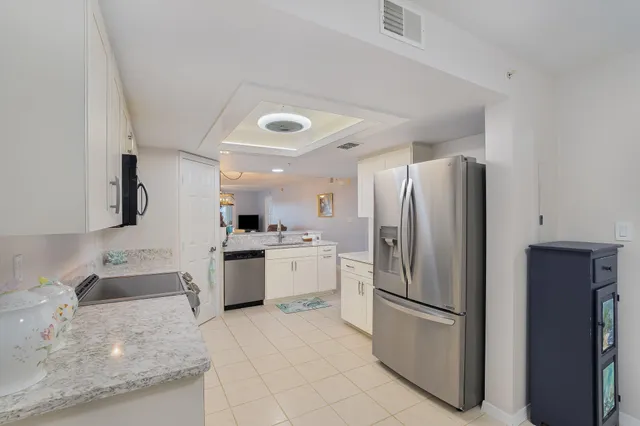 a kitchen with a refrigerator sink and stove