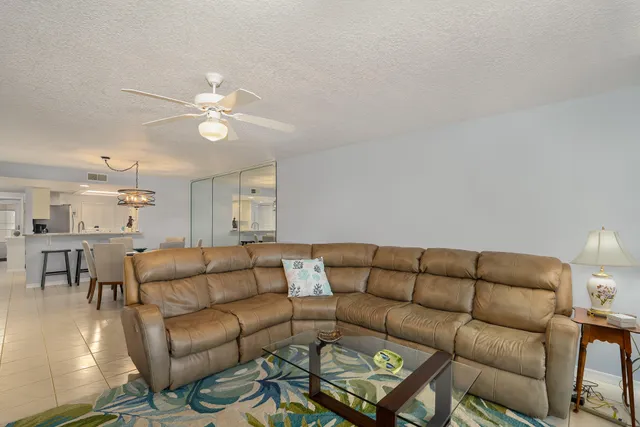 a living room with furniture a couch and wooden floor