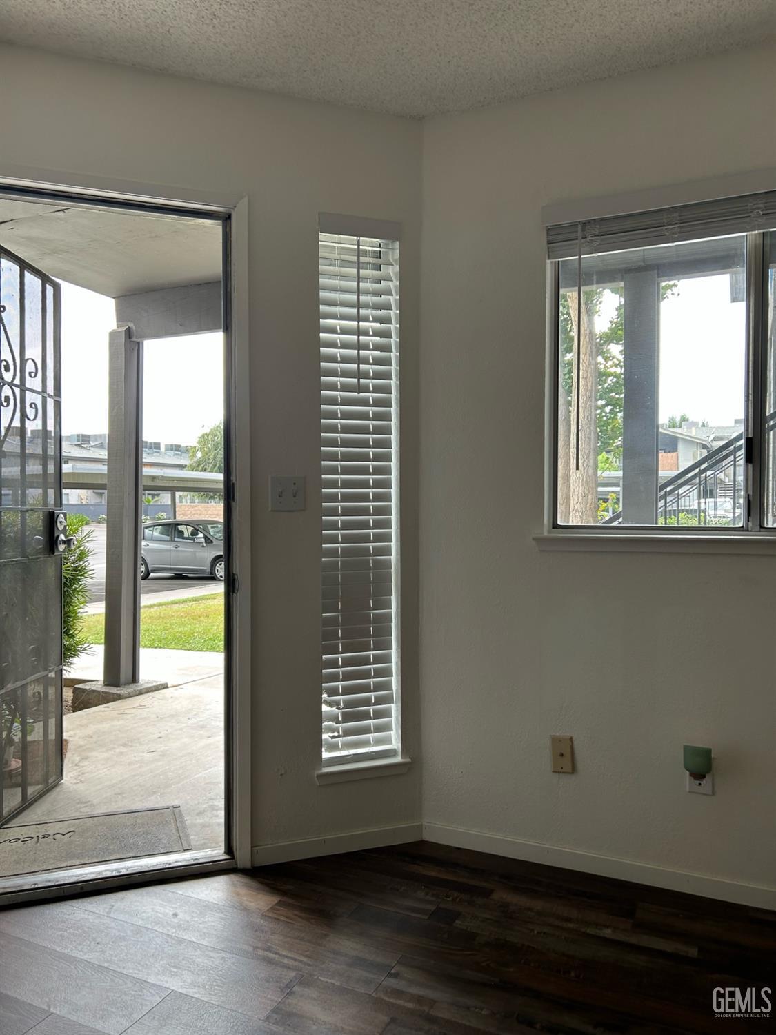 Undisclosed Address Bakersfield, CA 93309 - Photo 1 of 12 a view of an empty room with wooden floor and a window