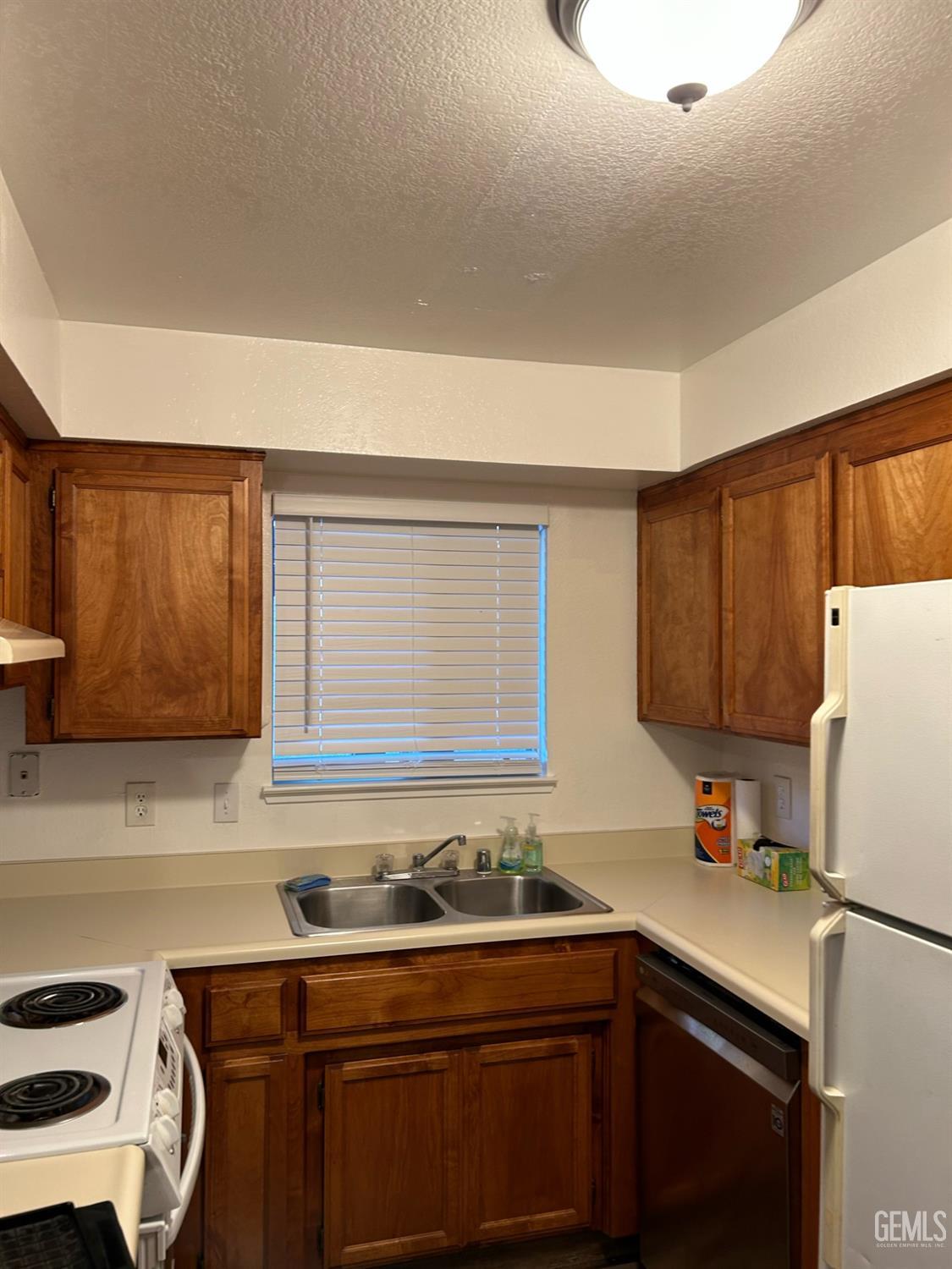 Undisclosed Address Bakersfield, CA 93309 - Photo 4 of 12 a kitchen with a sink cabinets and appliances