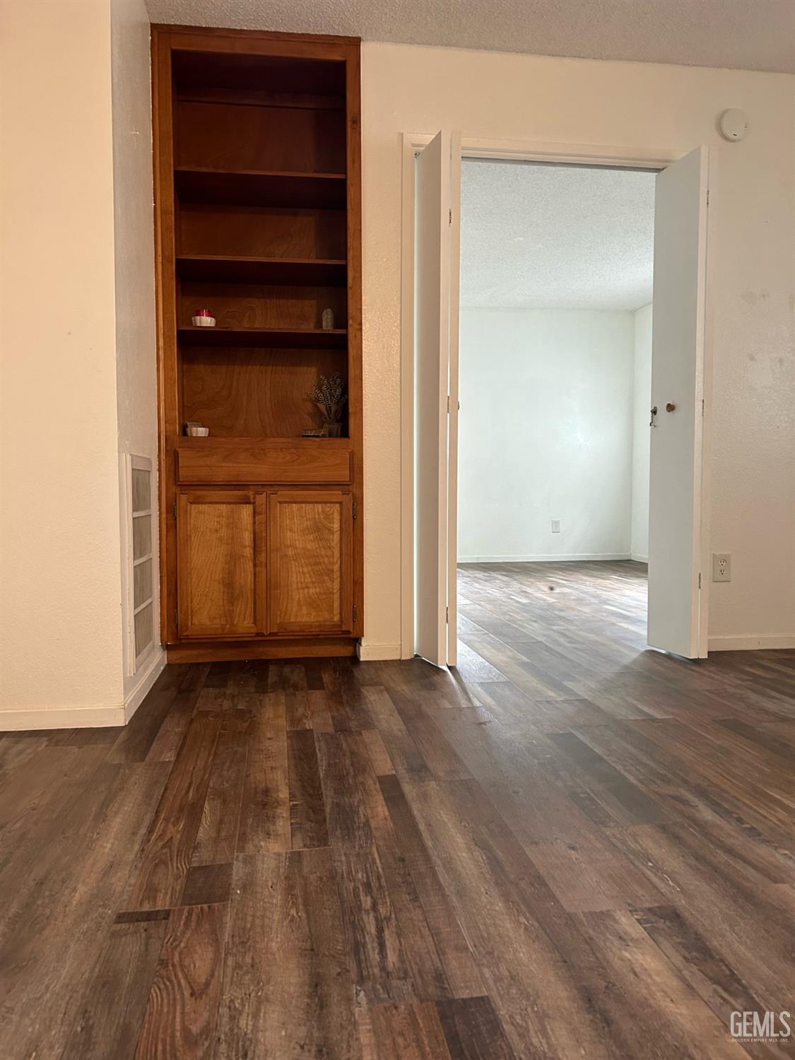 Undisclosed Address Bakersfield, CA 93309 - Photo 5 of 12 a view of an empty room with wooden floor and closet