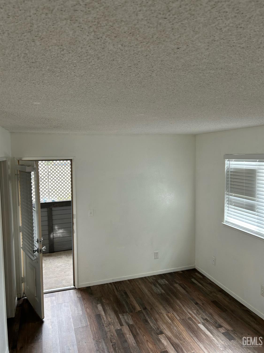 Undisclosed Address Bakersfield, CA 93309 - Photo 6 of 12 a view of empty room with wooden floor and fan