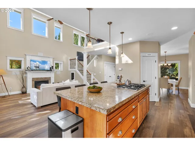 a kitchen with a stove a refrigerator and a dining table