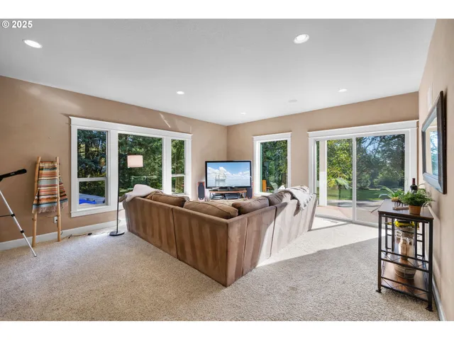 a living room with furniture and large windows